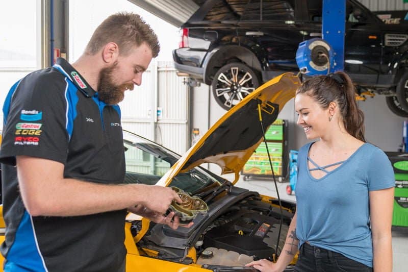 autoplus mechanic explaining faulty part to client